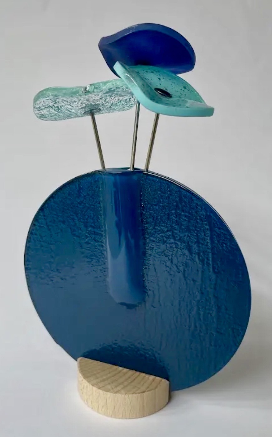 Modern glass flowers in vase in multiple colours