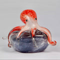 Pink glass Octopus on beach stone
